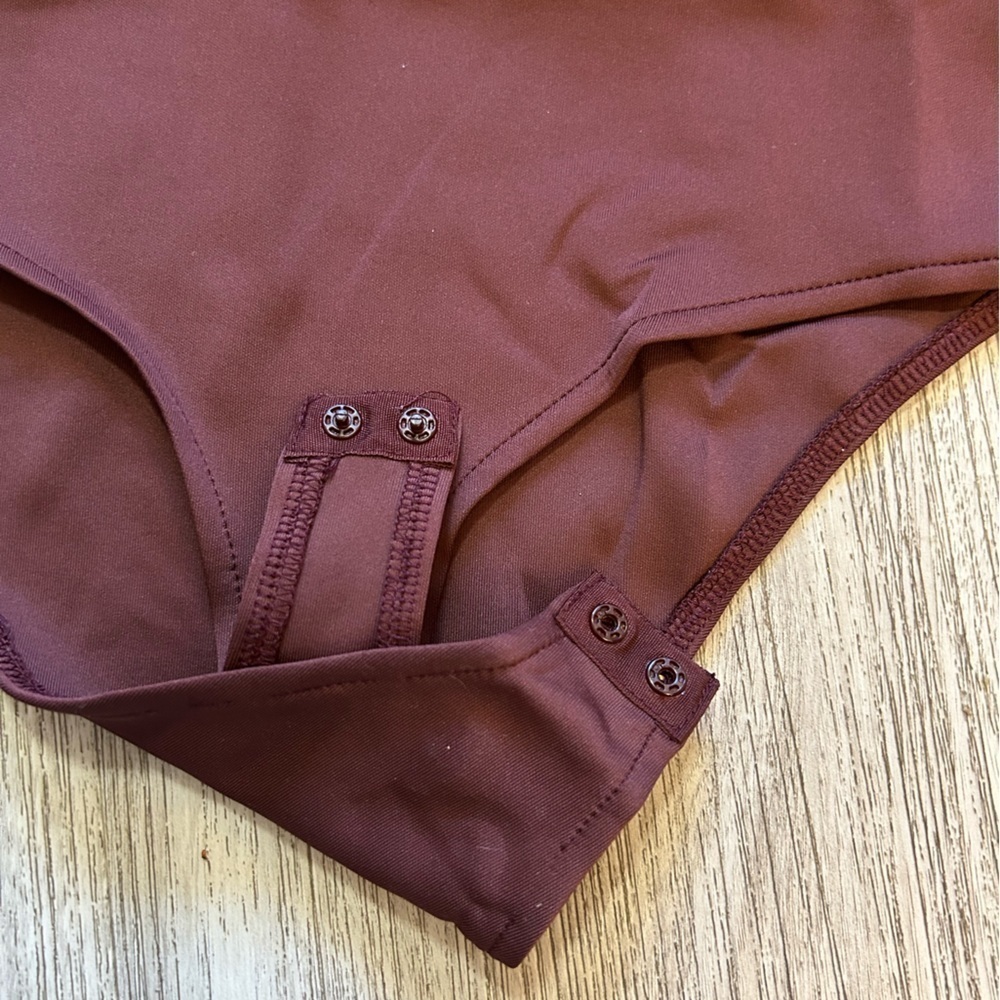 CHARLOTTE RUSSE burgundy one piece lace up bodysuit. New condition. Bottom snaps - Picture 5 of 6